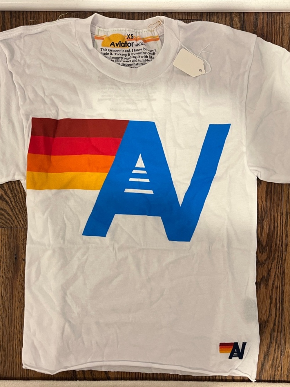 Aviator Nation ladies White Tee with Blue 'A' and Red-Orange-Yellow Stripes